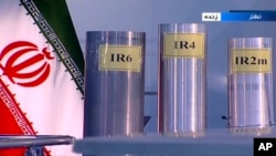 FILE - In this June 6, 2018, frame grab from Islamic Republic Iran Broadcasting, IRIB, state-run TV, three versions of domestically-built centrifuges are shown in a live TV program, from Natanz, an Iranian uranium enrichment plant, in Iran.