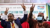 Yasir Arman, the deputy head of the Sudan People's Liberation Movement-North and secretary-general Ismail Khamis Jalab celebrate after the signing of a peace agreement between Sudan's power-sharing government and five key rebel groups, Aug 31, 2020.