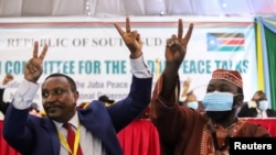 Yasir Arman, the deputy head of the Sudan People's Liberation Movement-North and secretary-general Ismail Khamis Jalab celebrate after the signing of a peace agreement between Sudan's power-sharing government and five key rebel groups, Aug 31, 2020.