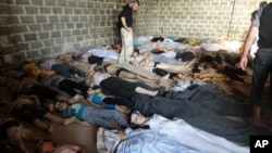 A photograph taken on August 22 purports to show some of the estimated 1,000 victims of a suspected chemical weapons attack in the Damascus suburb of East Ghouta, the day after a missile attacked by government forces. The government denies chemical weapons wer