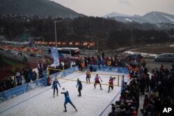 FILE - China's Xue Chen passes the ball during a snow volleyball exhibition match at Austria House in Pyeongchang, South Korea, Feb. 14, 2018.