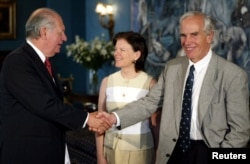 FILE - U.S. millionaire Douglas Tompkins (R), accompanied by his wife (C) shakes hands with Chilean President Ricardo Lagos (L) after signing an agreement at La Moneda Presidential Palace, in Santiago, Dec. 9, 2003.
