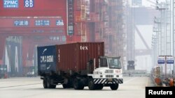 FILE - A trailer loaded with container boxes travels in Ningbo port in Zhejiang province, Jan. 22, 2015. 