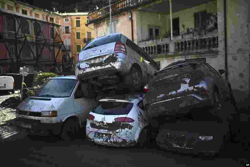 Cars stacked on top of each other by clean up crews are pictured in Breil-sur-Roya, near the border with Italy, Monday, Oct.5, 2020. Flooding has devastated mountainous areas in France&#39;s southeastern region of Alpes-Maritimes and Italy&#39;s northwestern regions of Liguria and Piedmont, after a storm swept through the two countries on Friday and Saturday. (AP Photo/Daniel Cole)