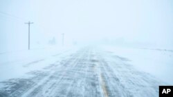 Snow blows and drifts over County Road K22 near Merrill, Iowa, on Jan. 12, 2024.