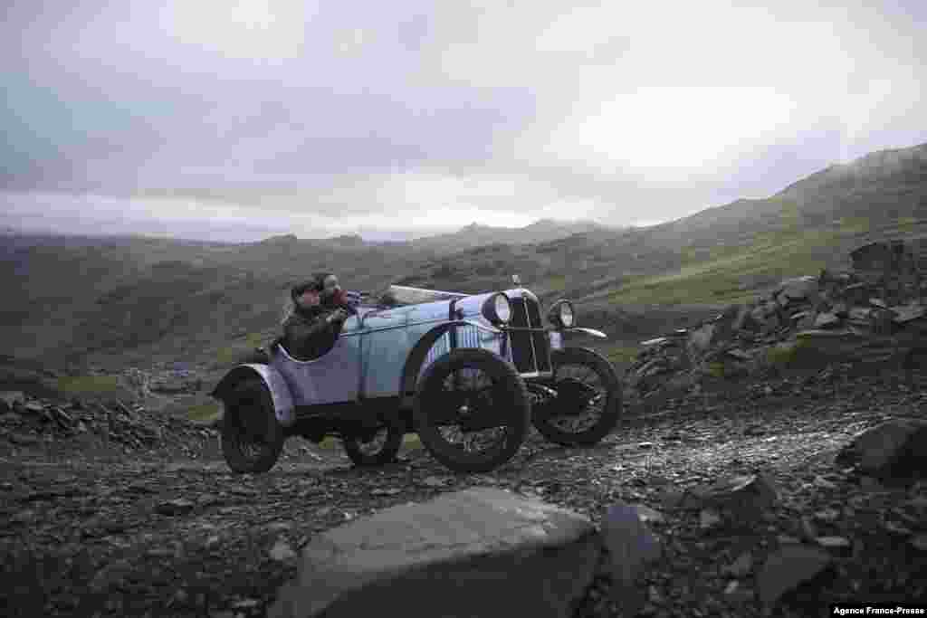 Alexandra Milne-Taylor drives an AJS 2 Seater Sports vintage car dating from 1930 as she takes part in the 52nd annual Lakeland Trial along a quarry road above Honister Slate Mine in Borrowdale, near Keswick, northern England on November 13, 2021.