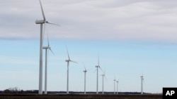 Wind turbines stand in a field, near Northwood, Iowa, Feb. 2, 2018.