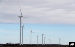 FILE - Wind turbines stand in a field, near Northwood, Iowa, Feb. 2, 2018.