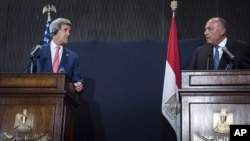 U.S. Secretary of State John Kerry (L) listens to Egypt's Foreign Minister Sameh Shoukry during a joint news conference in Cairo, Sept. 13, 2014. Kerry said on Saturday that Egypt has a critical role to play in countering Islamic State's ideology.
