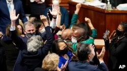 House Democrats celebrate after the House passage of President Joe Biden's expansive social and environment bill, at the Capitol, Nov. 19, 2021.