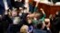 House Democrats celebrate after the House passage of President Joe Biden's expansive social and environment bill, at the Capitol, Nov. 19, 2021.