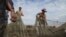 FILE: Fishermen check their fishing net on Tonle Sap, the Golden Lake of Cambodia.