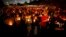People hold candles during a memorial service for Charleston Hartfield, an off-duty Las Vegas police officer who was killed during the mass shooting, in Las Vegas, Nevada, Oct. 5, 2017.