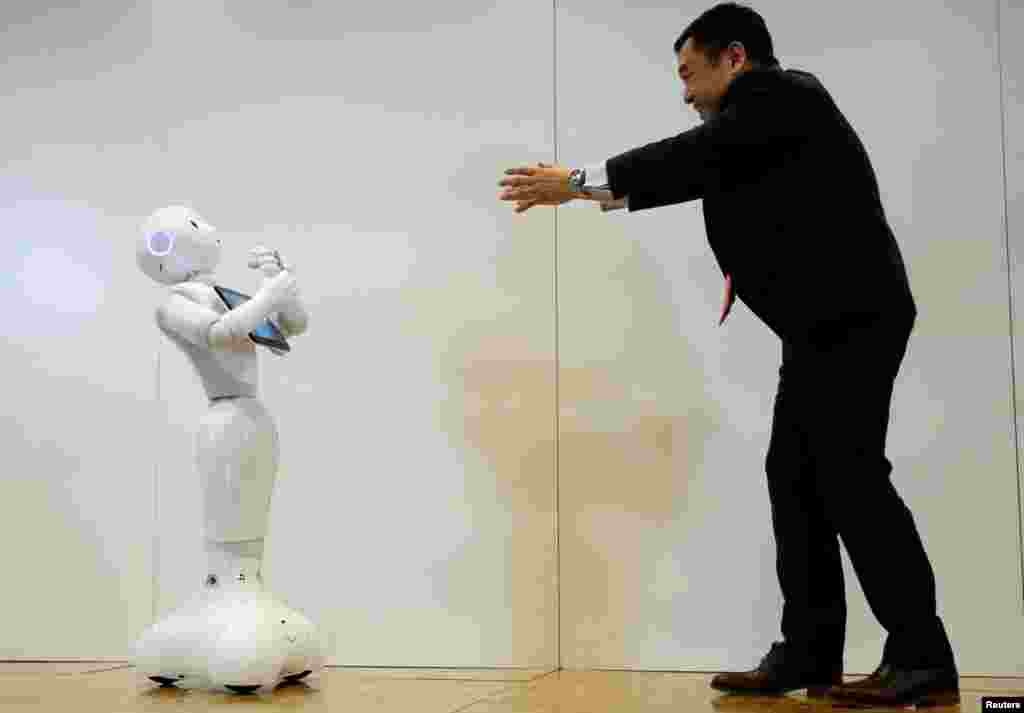 소프트뱅크 로보틱스의 카츠타카 하스미(오른쪽) 제품담당 이사가 감정에 반응하는 로봇 &#39;페퍼&#39;를 시연하고 있다. 구글의 안드로이드 운영체제와 호환성을 보여주기 위한 이번 시연은 일본 도쿄의 소프트뱅크 로보틱스 본사에서 진행됐다.