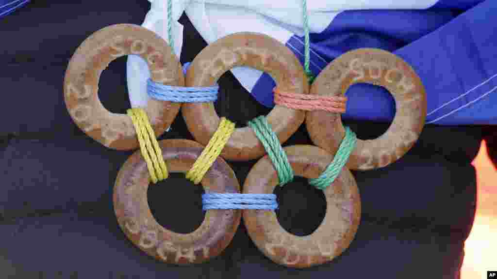 A spectator wears the Olympic rings made from bagels during the men's ski slopestyle qualifying at the Rosa Khutor Extreme Park, at the 2014 Winter Olympics, Feb. 13, 2014.