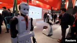 REUTERS Robots greeting visitors at Mobile World Congress