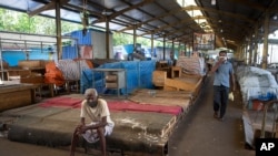 A Sri Lankan man rests in a vegetable market closed to curb the spread of the coronavirus in Colombo, Sri Lanka, June 16, 2021.