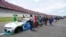 Nascar drivers Kyle Busch, left, and Corey LaJoie, right, join other drivers and crews as they push the car of Bubba Wallace to the front of the field prior to the start of the NASCAR Cup Series auto race at the Talladega Superspeedway, June 22, 2020.   