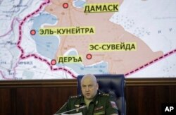 Colonel General Sergei Surovikin, commander of the Russian forces in Syria, speaks, with a map of Syria projected on the screen in the back, at a briefing in the Russian Defense Ministry in Moscow, June 9, 2017.