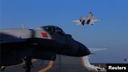 A live-fire drill using a Chinese aircraft carrier and jets is carried out in the Bohai sea, China, Dec. 14, 2016. 