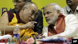 The Dalai Lama, left, speaks with Gujarat state Chief Minister Narendra Modi during an international seminar on Buddhist Heritage in Vadodara, south of Ahmadabad, India, Friday, Jan.15, 2010. The Dalai Lama inaugurated the three-day international seminar that began Friday. 