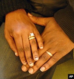 Hasson and Nicole show off their wedding rings.