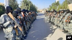 Taliban border fighters attend their graduation ceremony after a three-week training program in Lashkar Gah, Helmand province, Afghanistan, Oct. 25, 2021.