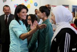 U.S. Ambassador to the United Nations Nikki Haley, second left, meets with Syrian refugee students, in Amman, Jordan, May 21, 2017.