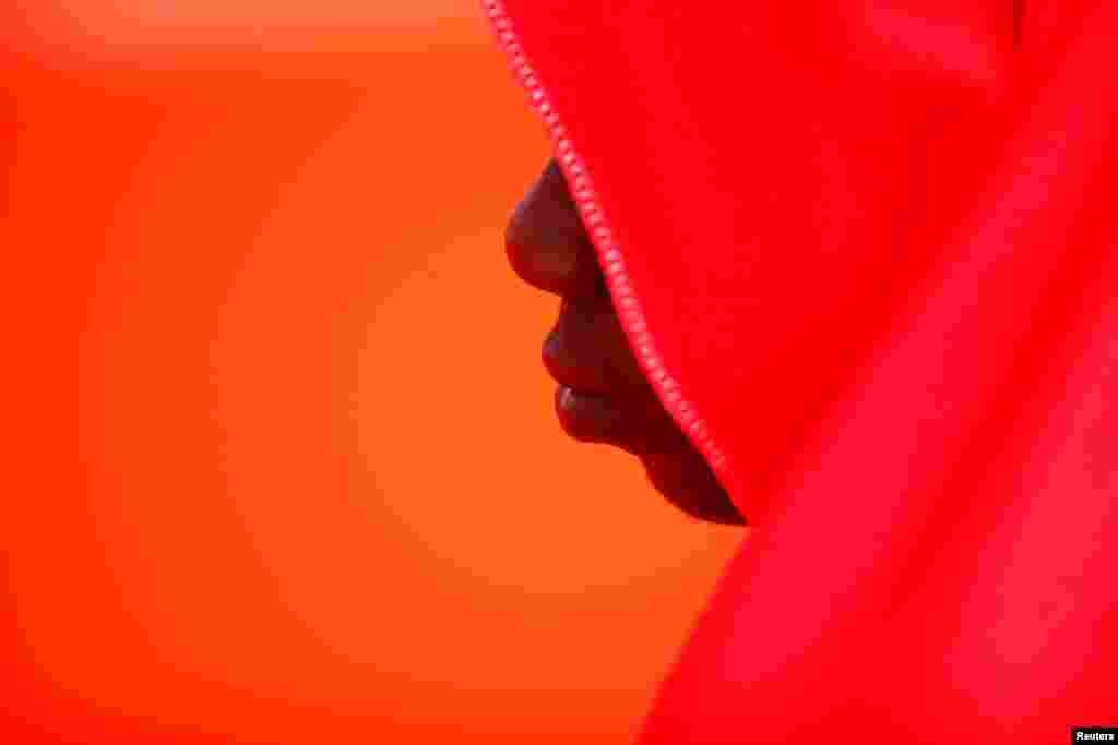 A migrant, part of a group intercepted aboard two dinghies off the coast in the Mediterranean Sea, rests on a rescue boat upon arrival at the port of Malaga, Spain.