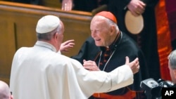 FILE - Pope Francis reaches out to hug Cardinal Archbishop emeritus Theodore McCarrick after the Midday Prayer of the Divine with more than 300 U.S. Bishops at the Cathedral of St. Matthew the Apostle in Washington, Sept. 23, 2015. 