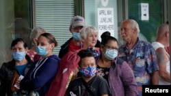 FILE - People line up outside a Kentucky Career Center hoping to find assistance with their unemployment claim in Frankfort, Kentucky, June 18, 2020. 