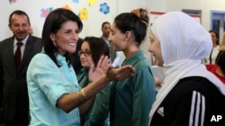 U.S. Ambassador to the United Nations Nikki Haley, second left, meets with Syrian refugee students, in Amman, Jordan, May 21, 2017.