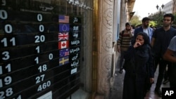 An exchange center displays rates for various currencies, in downtown Tehran, Iran, Oct. 2, 2018.