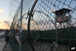 FILE - The sun rises over the Guantanamo detention facility at the Guantanamo Bay U.S. Naval Base, Cuba, May 13, 2009.