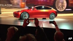 Tesla Motors unveils the new lower-priced Model 3 sedan at the Tesla Motors design studio in Hawthorne, California, March 31, 2016.
