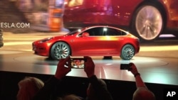 Tesla Motors unveils the new lower-priced Model 3 sedan at the Tesla Motors design studio in Hawthorne, California, March 31, 2016.