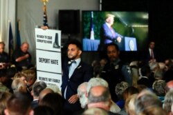 Virginia Del. Ibraheem Samirah, D-Fairfax, is escorted out after interrupting President Donald Trump as he spoke at an event marking the 400th anniversary of the first representative assembly, July 29, 2019, in Jamestown, Va.