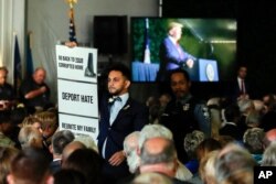 Virginia Del. Ibraheem Samirah, D-Fairfax, is escorted out after interrupting President Donald Trump as he spoke at an event marking the 400th anniversary of the first representative assembly, July 29, 2019, in Jamestown, Va.