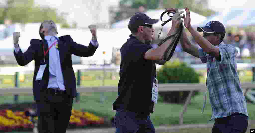 Los cuidadores de "I&acute;ll Have Another" Inocencio Diaz y Benjamin P&eacute;rez celebran la victoria en el Preaknnes junto a Jack Sistrunk. (AP)