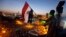An Egyptian protester waves a national flag over Tahrir Square, the focal point of Egyptian uprising as opponents of President Mohamed Morsi are gathered in Cairo, June 28, 2013.