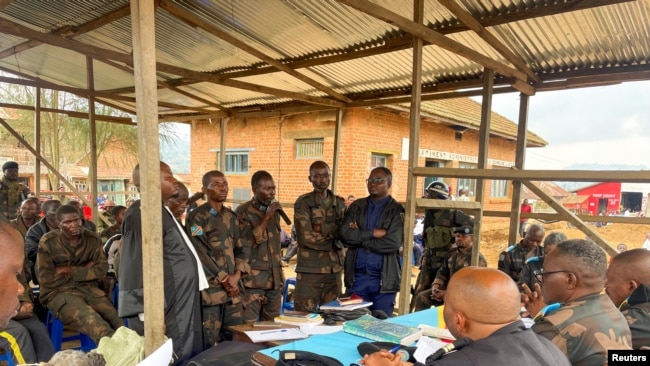 Group of Congolese soldiers, accused of fleeing combat against M23 rebels, take part in their trial, in Lubero, North Kivu Province, Democratic Republic of Congo on July 5, 2024. (Yassin Kombi/REUTERS)