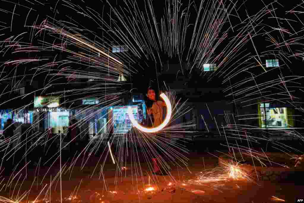 A Palestinian plays with firecrackers as he celebrates the Muslim holy month of Ramadan in the town of Rafah in the southern Gaza Strip.