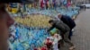 (FILE) Ukraine's President Volodymyr Zelenskyy and German Chancellor Olaf Scholz attend a ceremony of honoring fallen soldiers near the People's Memorial of National Memory in Kyiv, Dec.2, 2024.