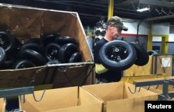 Randy Blantz, 57, unloads Chinese-made wheels near the end of the assembly line at the AMES Companies wheelbarrow factory, the largest wheelbarrow factory in the world, in Harrisburg, Pennsylvania, June 29, 2017.