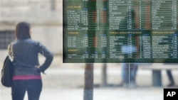 A stock exchange monitor displays the market trends in Milan, Italy, November 9, 2011.