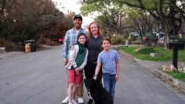 FILE The Morgan family, who relocated from San Francisco so the children could attend school in-person, pose for a portrait near their rental house in Austin, Texas, U.S., March 14, 2021. Picture taken March 14, 2021.