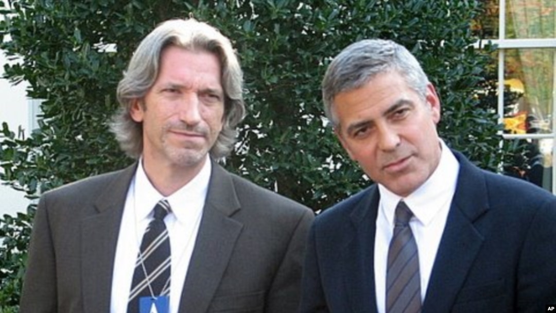 Actor, activist George Clooney (R) with activist John Prendergast