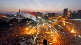 A protester waves a flag as Egyptians gather in Tahrir Square during a demonstration against President Mohamed Morsi in Cairo, June 30, 2013.
