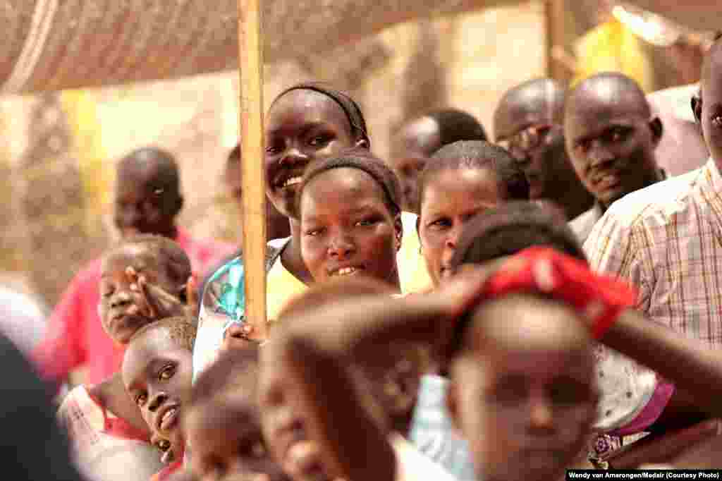 Displaced South Sudanese, some of whom have lived for months at the UNMISS Tomping camp in Juba, wait in line to receive a dose of oral cholera vaccine.