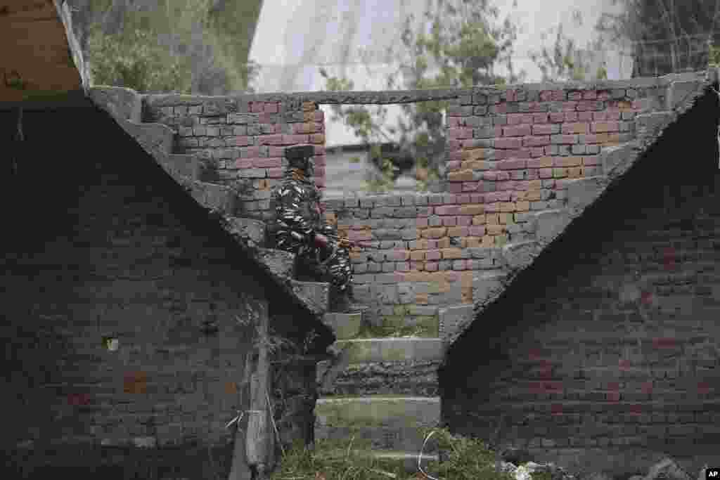 An Indian paramilitary soldier keeps guard near the site of an attack in Shopian, south of Srinagar, Indian-controlled Kashmir.
